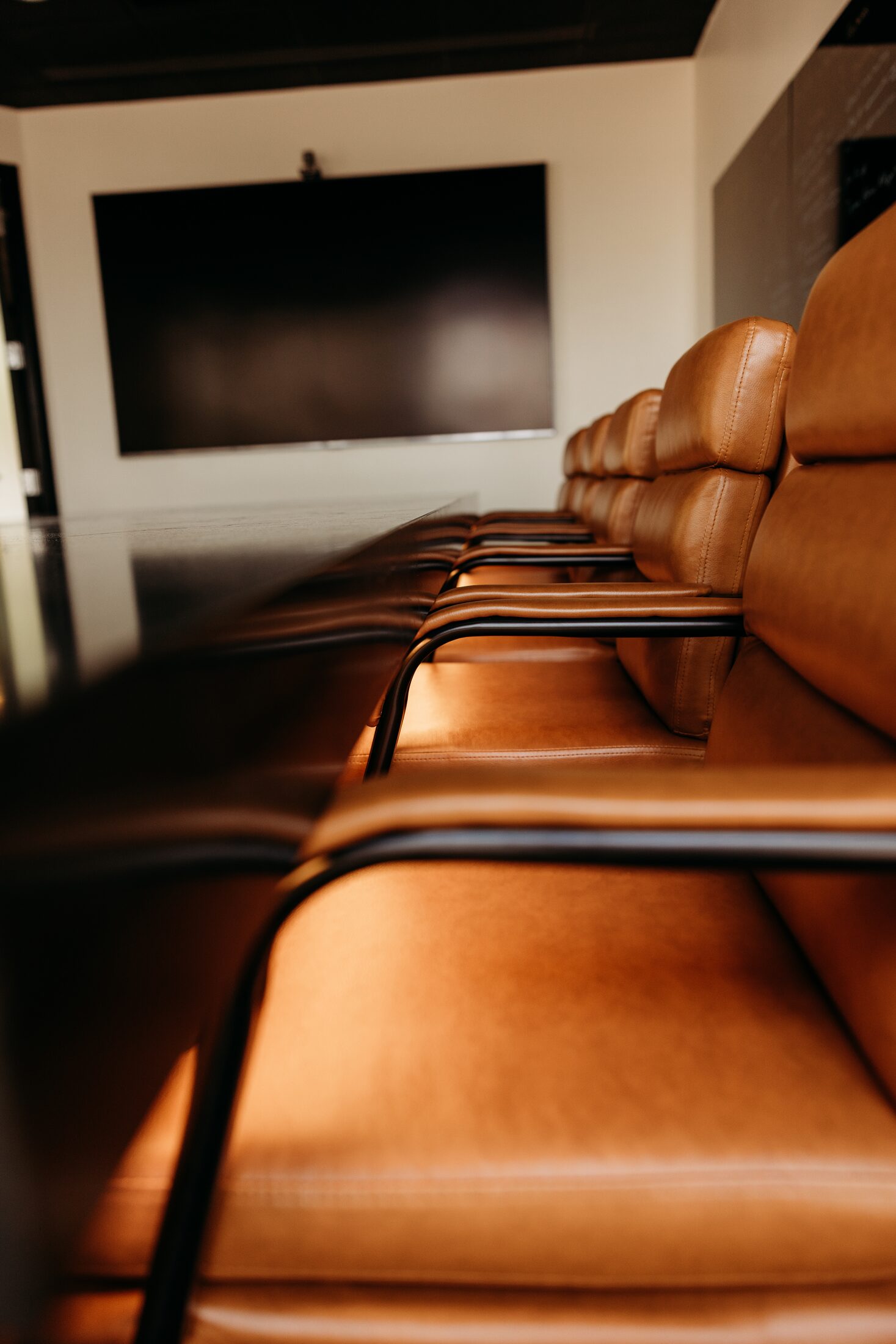 Executive leather chair pulled up to a custom stone conference table in Arizona