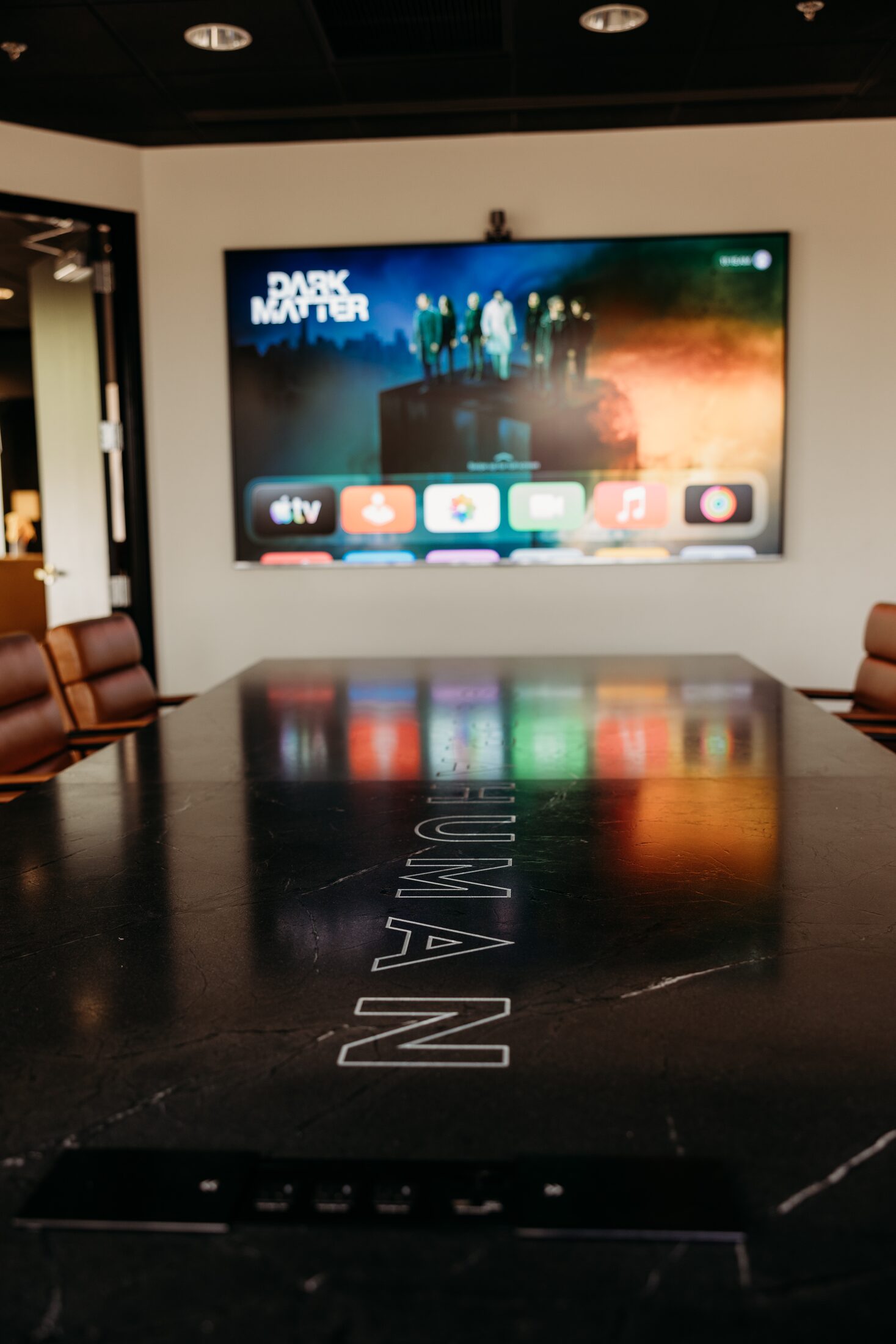 Arizona boardroom with a wall display and a custom conference table with integrated connectivity